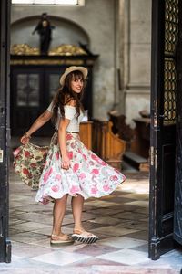 Portrait of smiling young woman standing at doorway in church