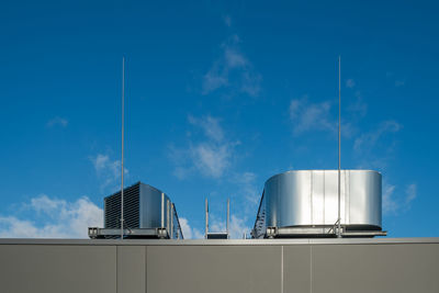 Low angle view of air duct on building against sky