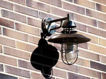 Electric lamp hanging against wall
