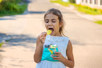 Cute girl eating potato chip