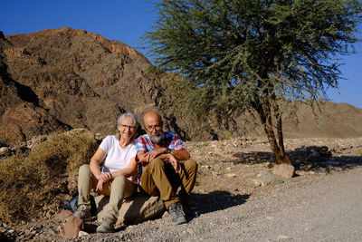 Senior couple sitting in the desert 