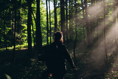 Rear view of man with beards standing in forest