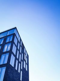 Low angle view of building against clear blue sky