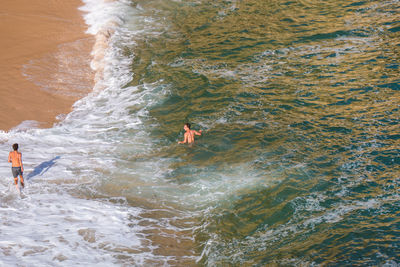 High angle view of people in sea