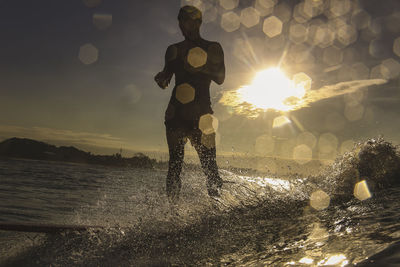Silhouette of surfer at sunset