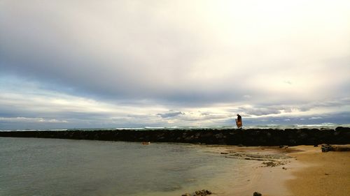 Scenic view of sea against cloudy sky