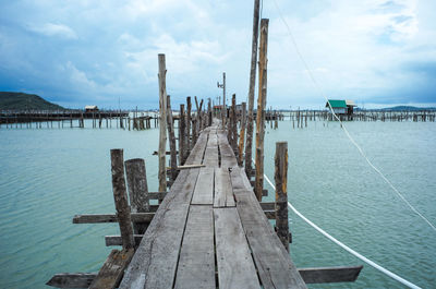 Native fisherman house and traditional fishing farm at the coast of sea with old wooden walkway