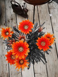 High angle view of orange flowering plants on wood