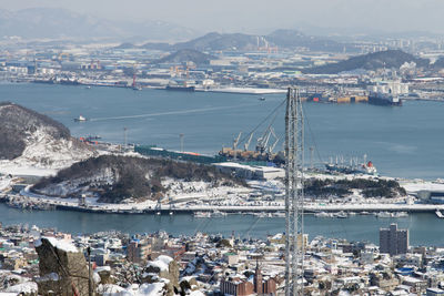 High angle view of harbor and buildings in city