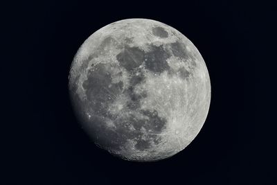 Low angle view of moon against clear sky at night