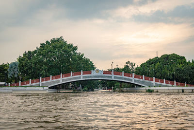 Bridge over river against sky during sunset
