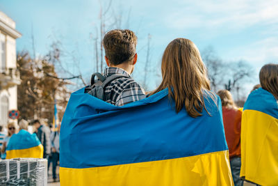 Rear view of woman standing in city