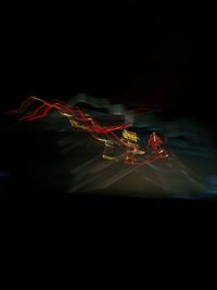 Close-up of illuminated light over black background