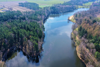 Aerial view of a lake in the heath in northern germany for recreational use, with dense forest 