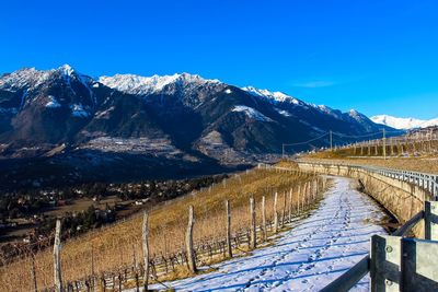 Scenic view of snowcapped mountains against blue sky