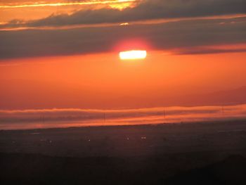 Scenic view of sea against orange sky