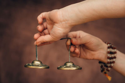 Cropped hands of person holding cymbal