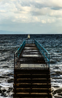 Pier over sea against sky