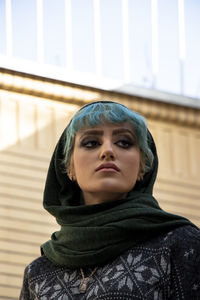 Portrait of young woman standing outdoors