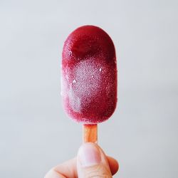 Close-up of hand holding ice cream