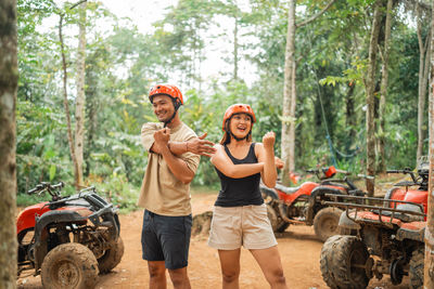 Portrait of smiling friends in forest