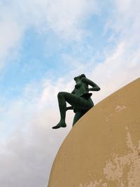 Low angle view of statue against sky