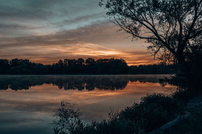 Scenic view of lake against sky during sunrise 