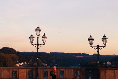 Street light against sky at sunset