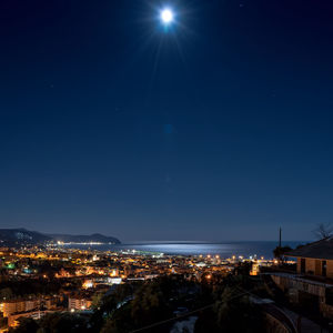 High angle view of illuminated city against sky at night