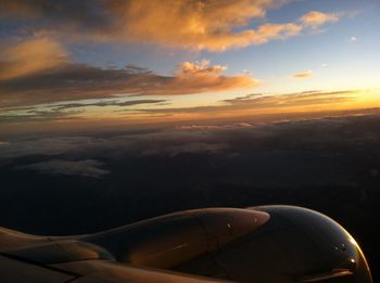 Cropped image of airplane flying over sea