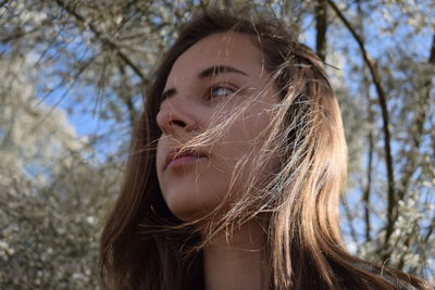 Portrait of woman against tree