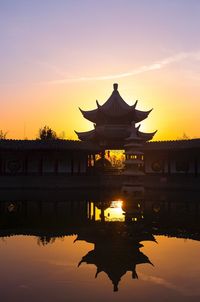 Silhouette of building against sky during sunset