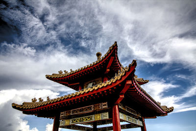 Low angle view of temple against cloudy sky