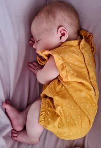 High angle view of cute baby sleeping