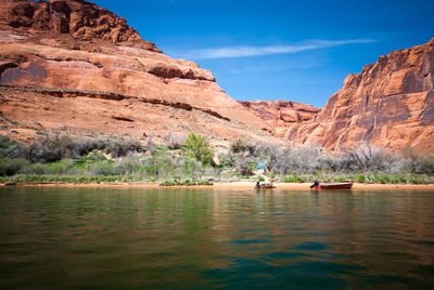 Scenic view of river with mountains in background