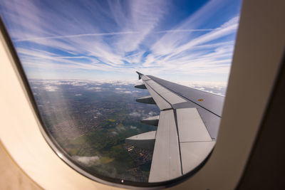 View of airplane flying through glass window