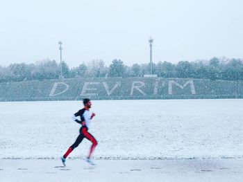 Full length of man running on snow