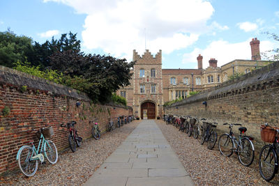 Bicycle parked outside building against sky