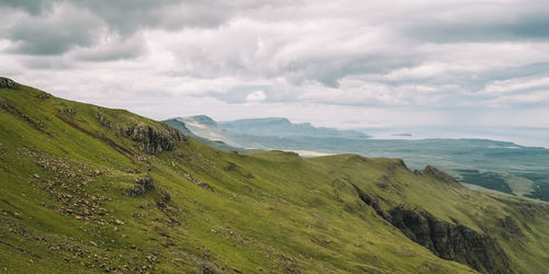 Scenic view of sea and mountains against sky