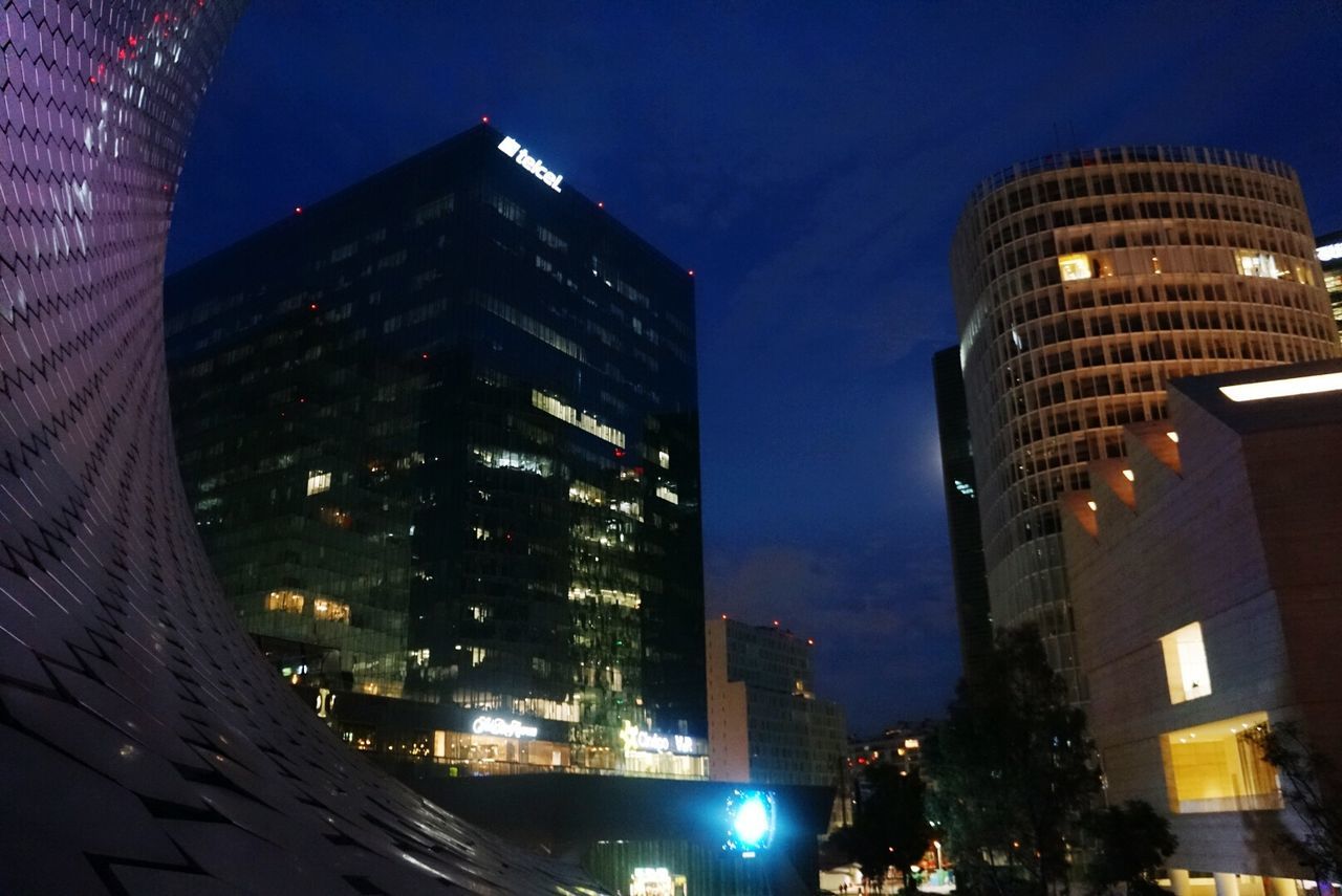 building exterior, architecture, illuminated, built structure, night, city, low angle view, skyscraper, modern, office building, sky, tall - high, tower, building, dusk, residential building, city life, outdoors, blue, no people