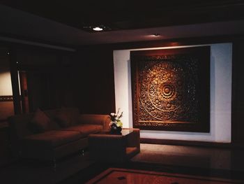 Illuminated electric lamp on sofa at home