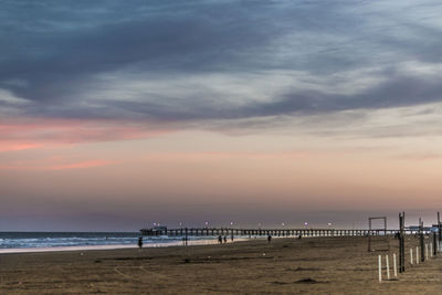 Scenic view of beach against sky during sunset