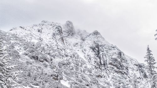 Low angle view of snowcapped mountain against sky