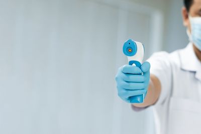 Midsection of man holding umbrella