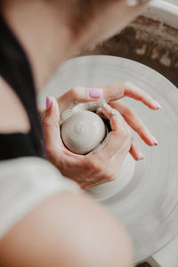 Midsection of woman at pottery workshop