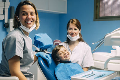 Dentists examining patient in clinic