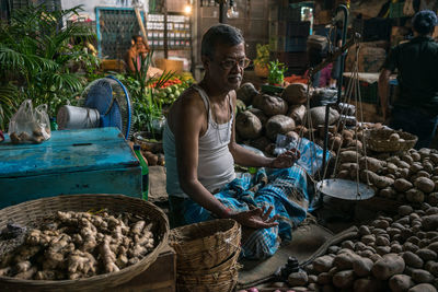 People in basket for sale at market stall