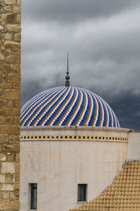 Building against cloudy sky