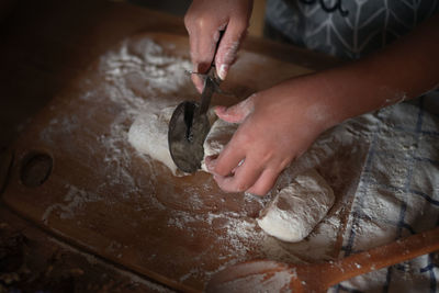 Cropped hands of girl preparing food at home