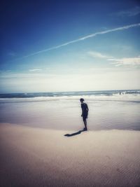 Man on beach against sky